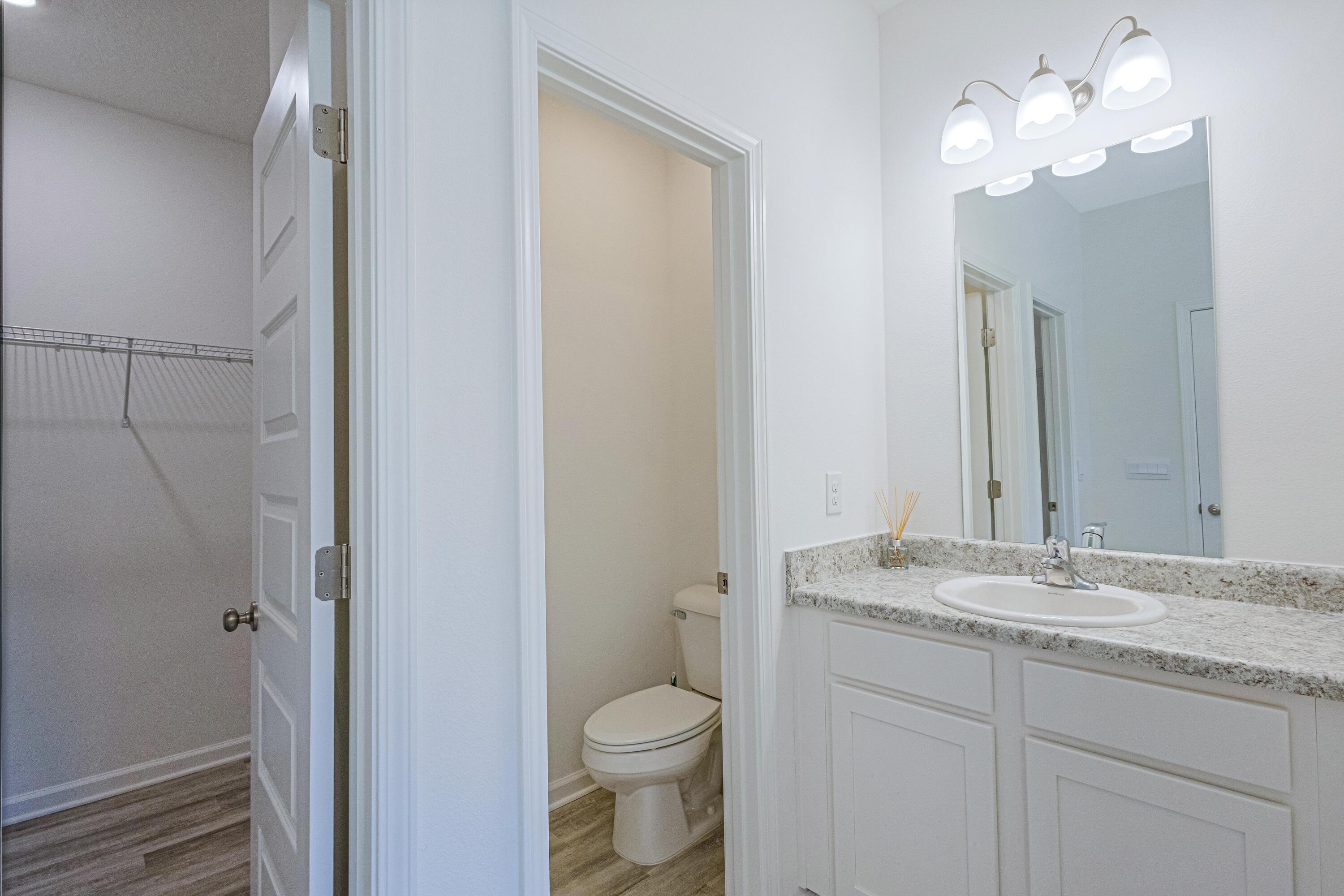 16 Woodsorrel Street Freeport, FL 32439 - Photo 10 of 23 a bathroom with a granite countertop sink toilet and a mirror