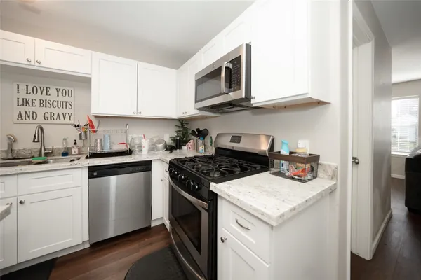 a kitchen with stainless steel appliances granite countertop a stove and a microwave
