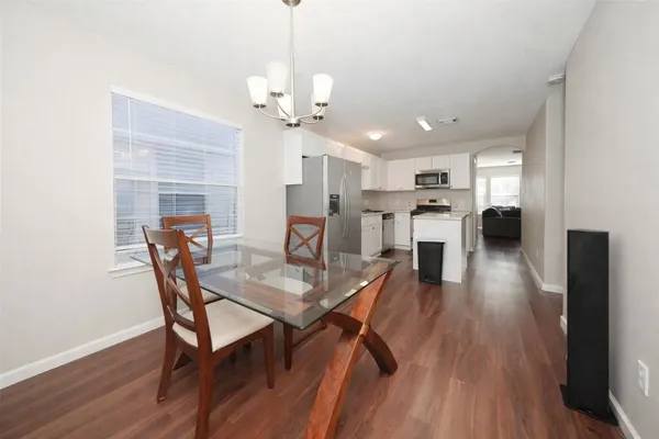 a view of a dining room with furniture and wooden floor