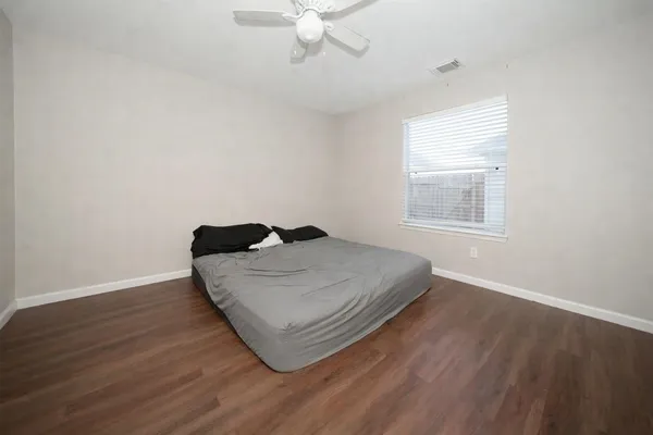 a bedroom with a bed and window
