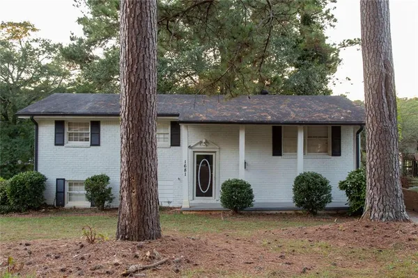 a view of a house with a tree and front view of a house