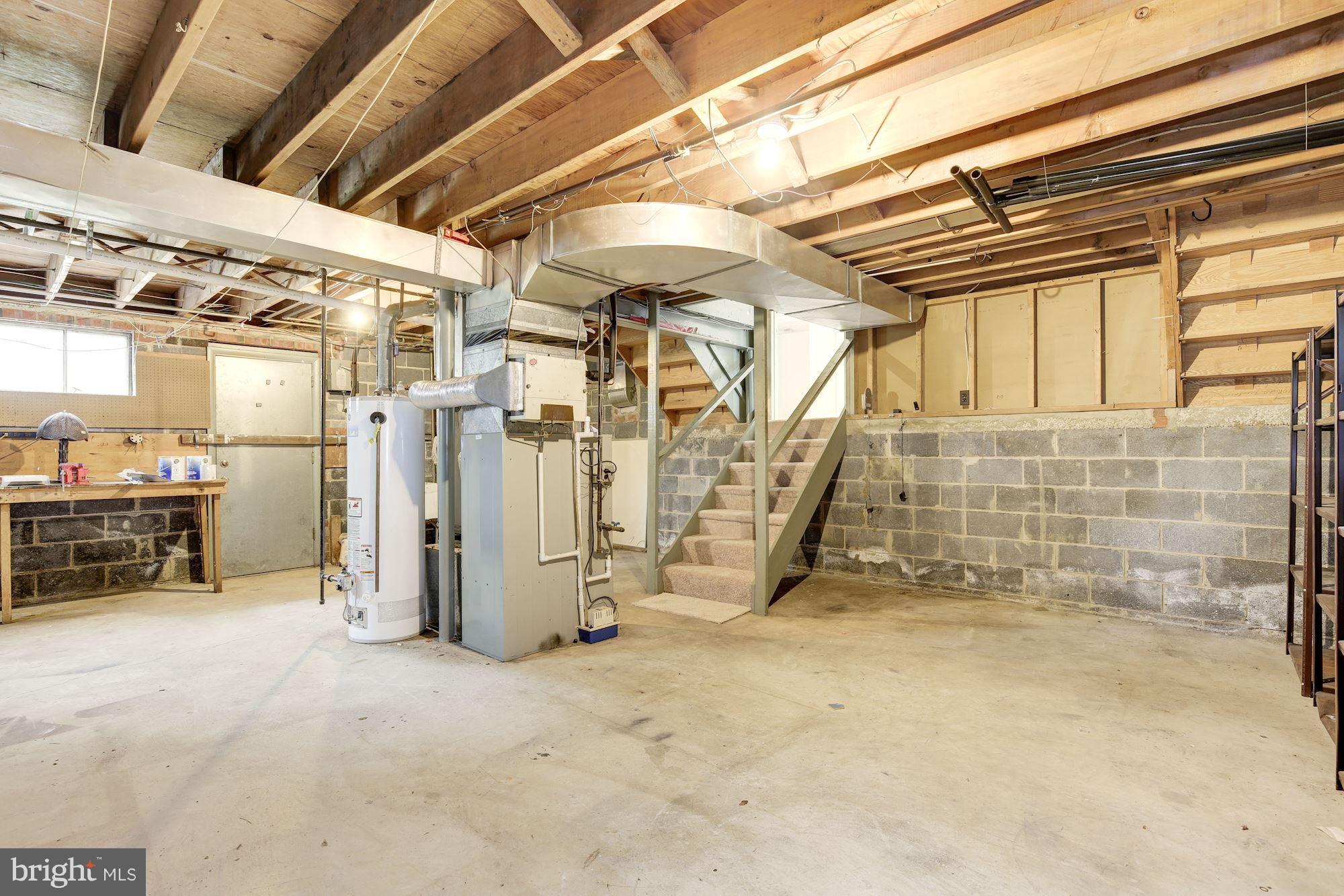 12121 Arbie Road Silver Spring, MD 20904 - Photo 27 of 30 Large unfinished basement with rear exit