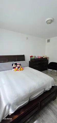 a bedroom with a bed and a dresser