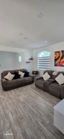 a living room with furniture and a window