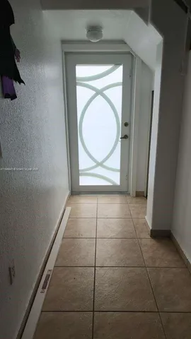 a view of a patio with table and chairs with wooden floor