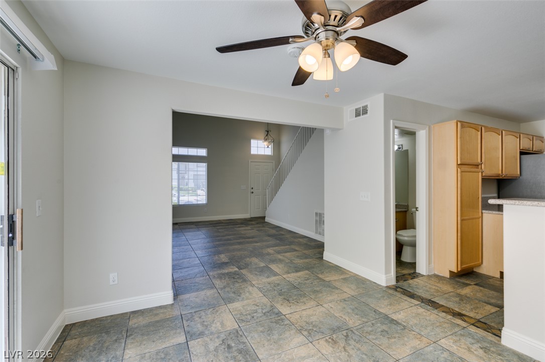 200 Luninborg Street Henderson, NV 89074 - Photo 37 of 40 A versatile open layout welcomes with tiled flooring, creating a seamless flow from the living area to the kitchen.