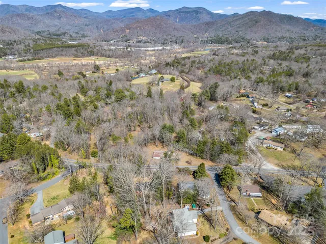 a view of lake with mountain and trees