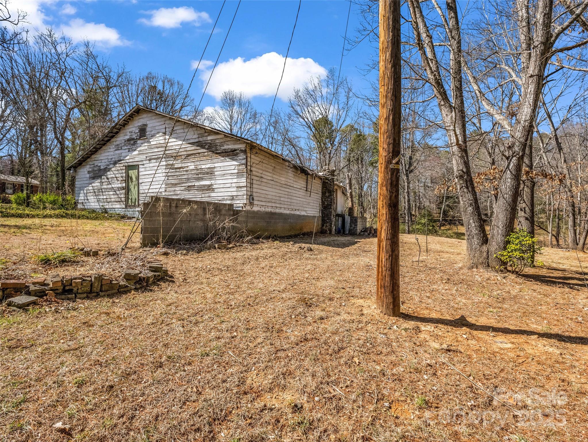 156 Warren Wilson Road Swannanoa, NC 28778 - Photo 8 of 38 a view of a house with a yard covered in snow