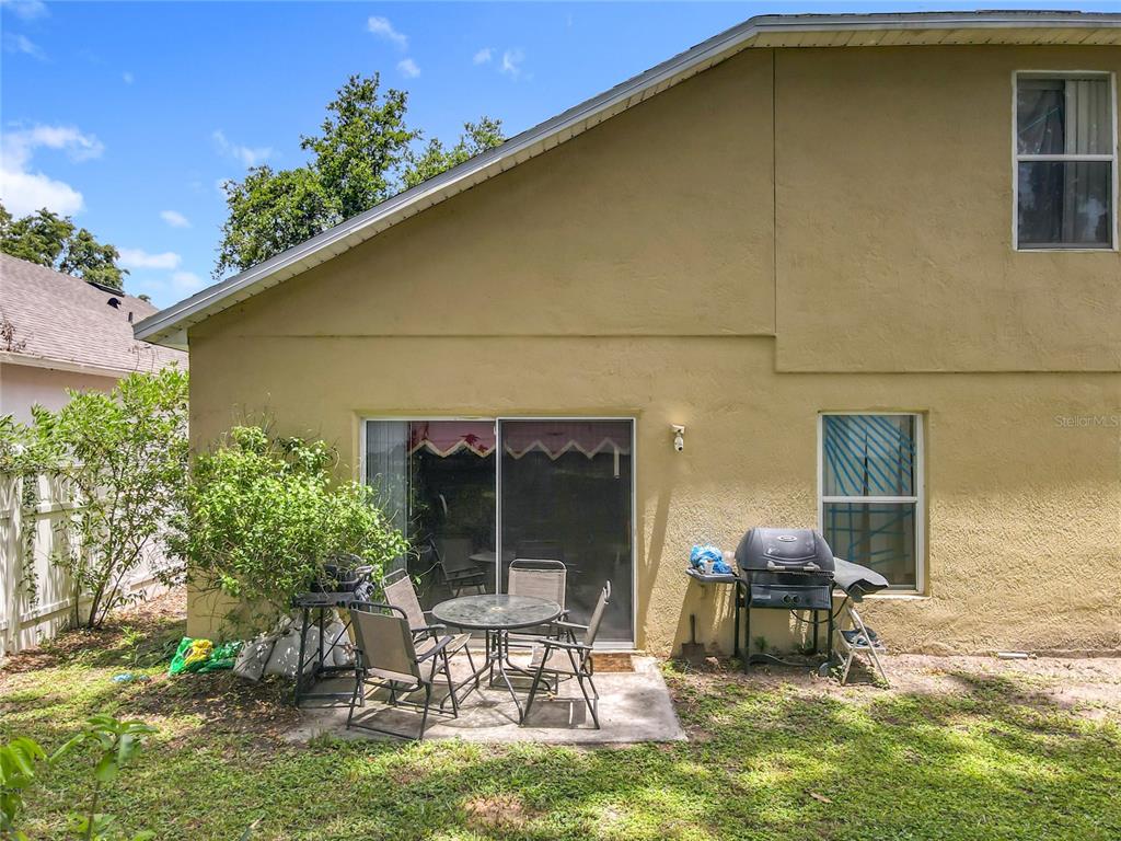 7939 Riffle Lane Orlando, FL 32818 - Photo 39 of 52 a backyard of a house with yard and outdoor seating