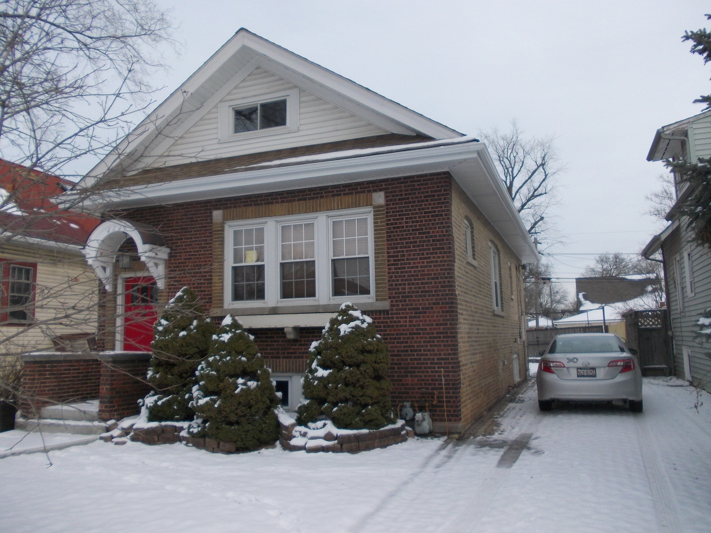 a couple of cars parked in front of a house
