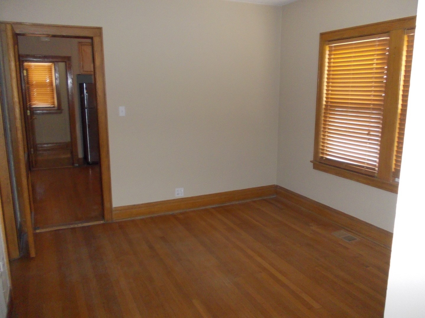 4145 Eberly Avenue Brookfield, IL 60513 - Photo 3 of 13 a view of an empty room with wooden floor and a window