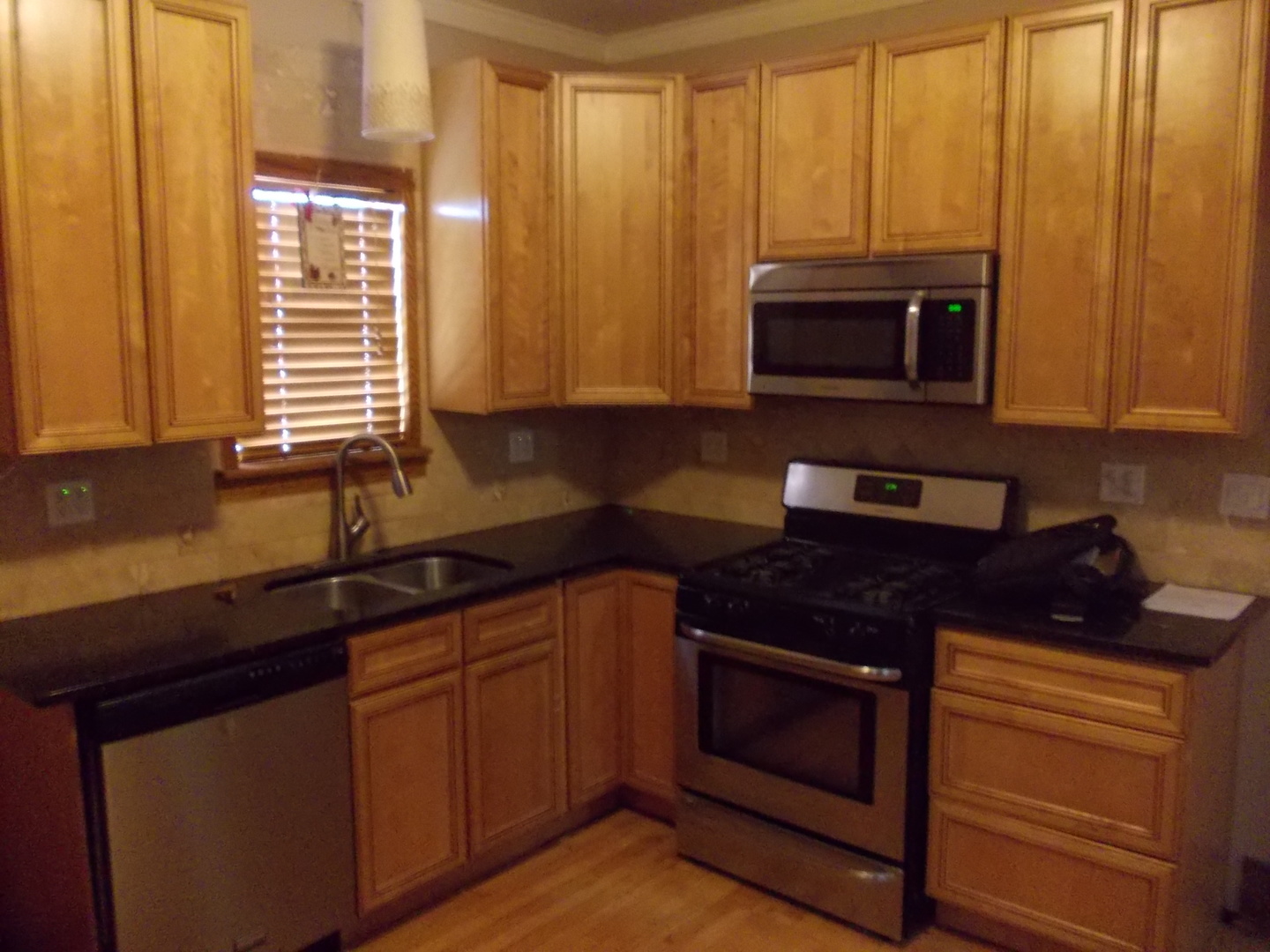 4145 Eberly Avenue Brookfield, IL 60513 - Photo 5 of 13 a kitchen with granite countertop a stove top oven microwave and cabinets
