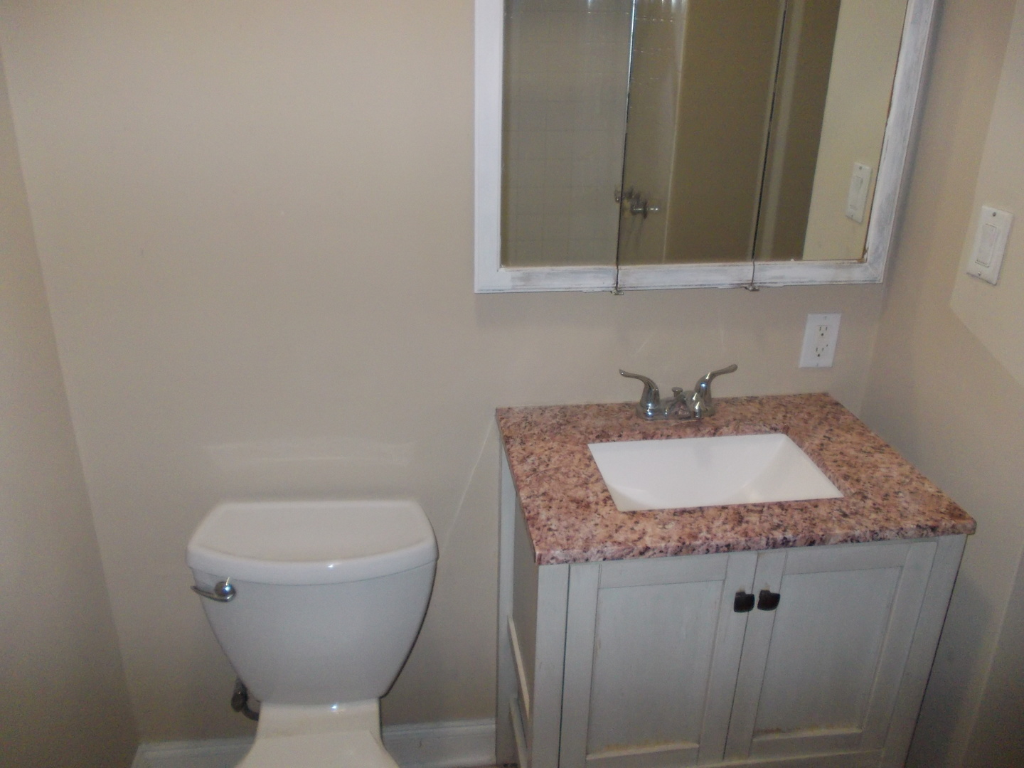 4145 Eberly Avenue Brookfield, IL 60513 - Photo 6 of 13 a bathroom with a toilet sink and mirror