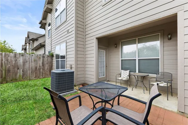 a backyard of a house with table and chairs