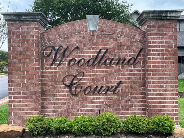 a brick building with a yard