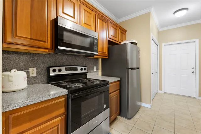 a kitchen with stainless steel appliances granite countertop a refrigerator stove and microwave