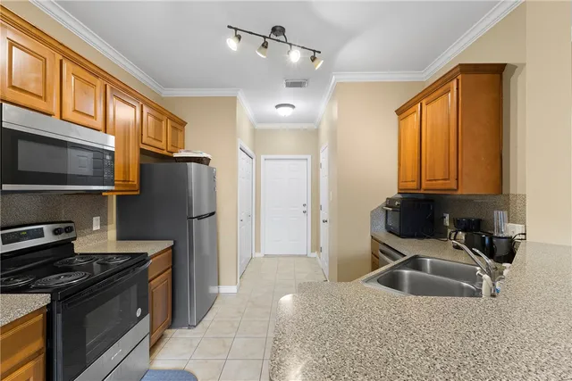 a kitchen with a sink stove and refrigerator