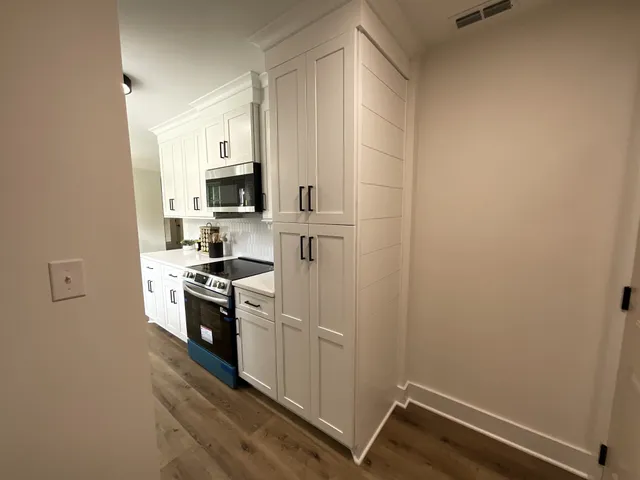 a kitchen with a sink stove and microwave