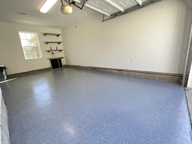an empty room with windows and ceiling fan