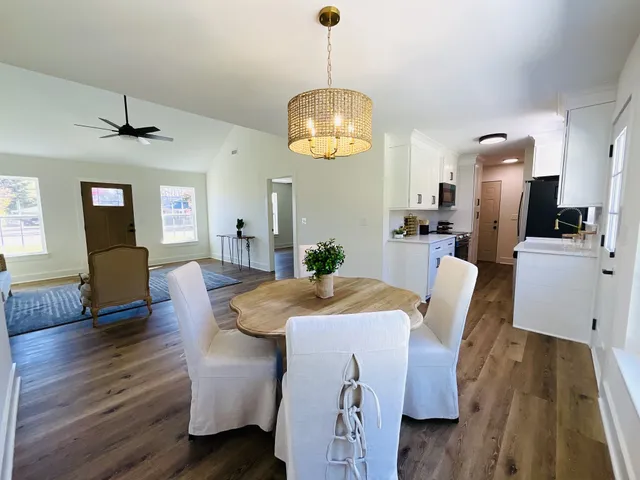 a view of a dining room with furniture and wooden floor