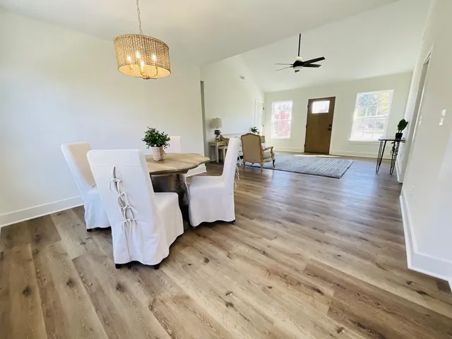 a view of a livingroom with furniture wooden floor and chandelier