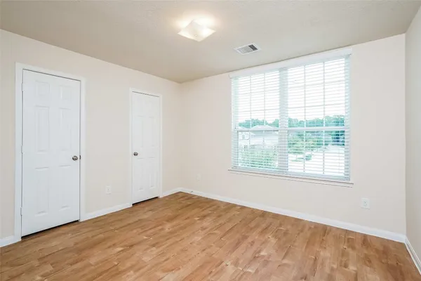 a bathroom with a granite countertop sink a toilet a mirror and shower
