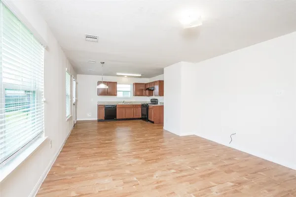 a kitchen with granite countertop stainless steel appliances a sink stove and cabinets