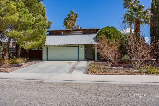 712 Peg Street Ridgecrest, CA 93555 - Photo 1 of 44 a front view of a house with a yard and garage