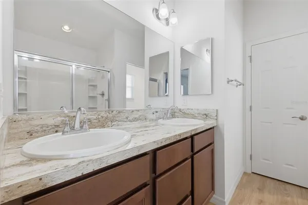 a bathroom with a granite countertop sink and a mirror