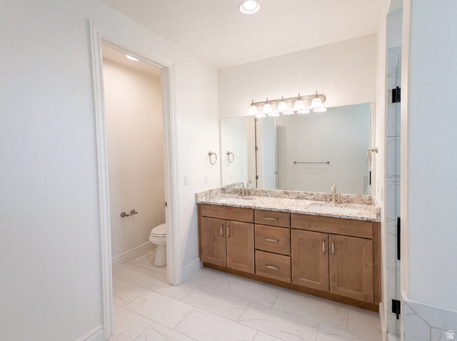 1251 North 2525 West Clinton, UT 84015 - Photo 17 of 30 Double vanity with light wood-finish cabinetry and granite-style countertop