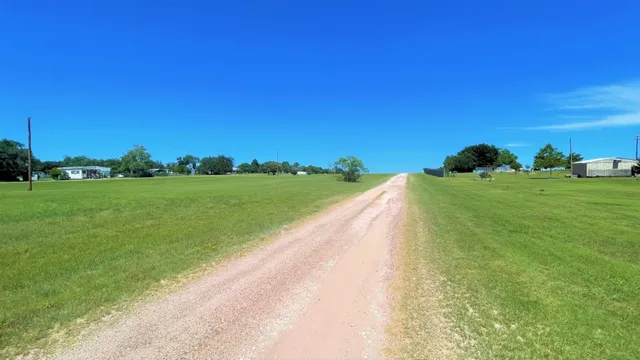 a view of a street with a big yard