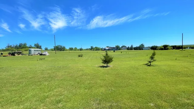 a view of a golf course with an ocean