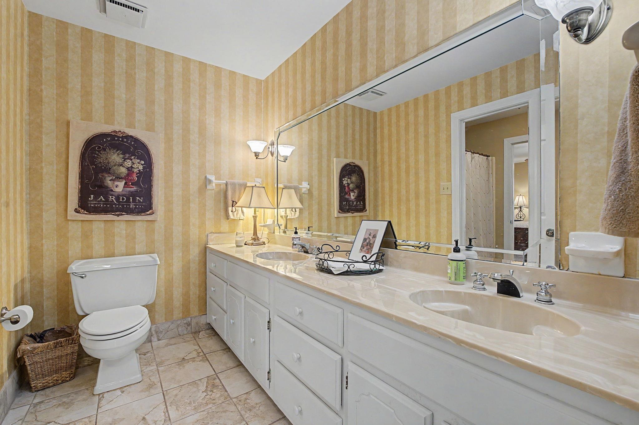1929 Miller Farms Road Germantown, TN 38138 - Photo 17 of 40 Bathroom featuring a dual vanity with integrated sinks, a stone-finish countertop, and white cabinetry
