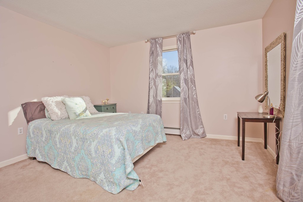 51 Crest Road Monson, MA 01057 - Photo 14 of 30 a spacious bedroom with a bed and a table
