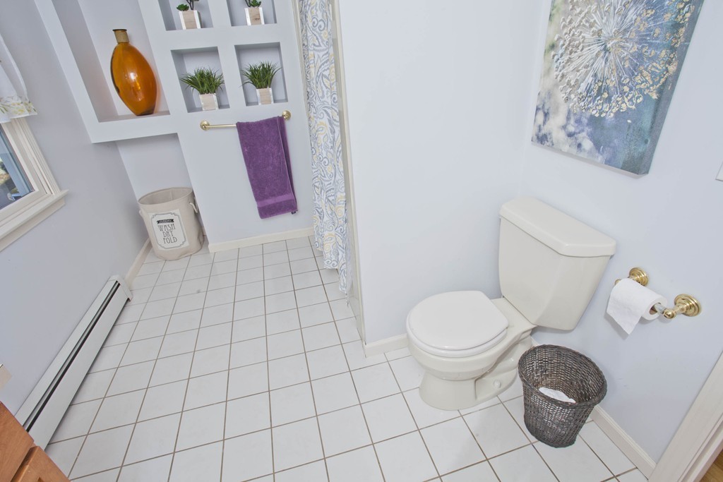 51 Crest Road Monson, MA 01057 - Photo 17 of 30 a bathroom with a toilet and a shower curtain