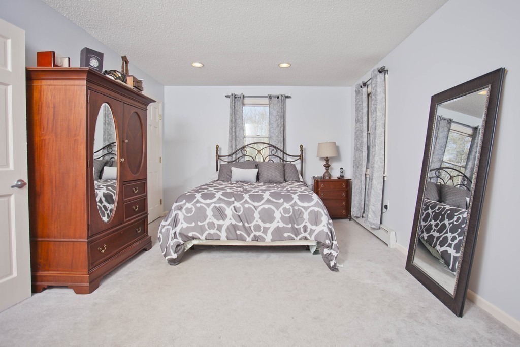 51 Crest Road Monson, MA 01057 - Photo 18 of 30 a bedroom with a bed and a mirror