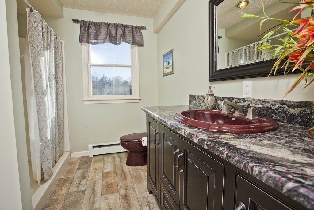 51 Crest Road Monson, MA 01057 - Photo 20 of 30 a kitchen with a sink a stove and a wooden floor