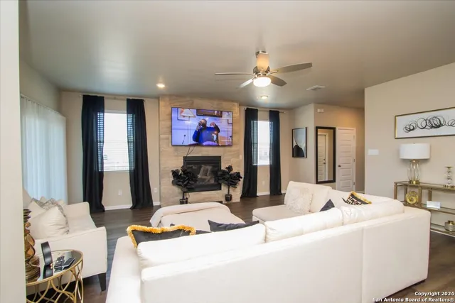 a living room with fireplace furniture and a flat screen tv
