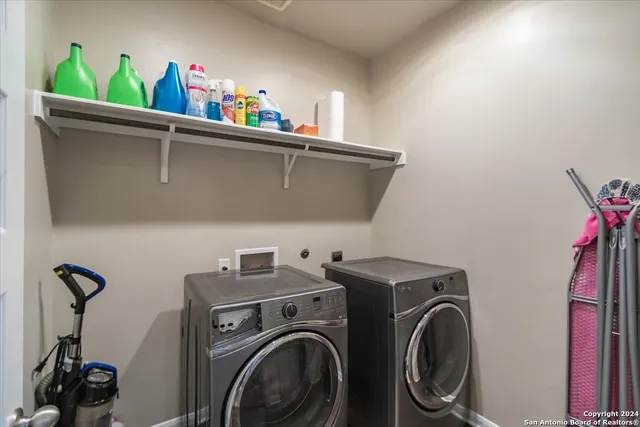 a utility room with dryer washer and shoe rack