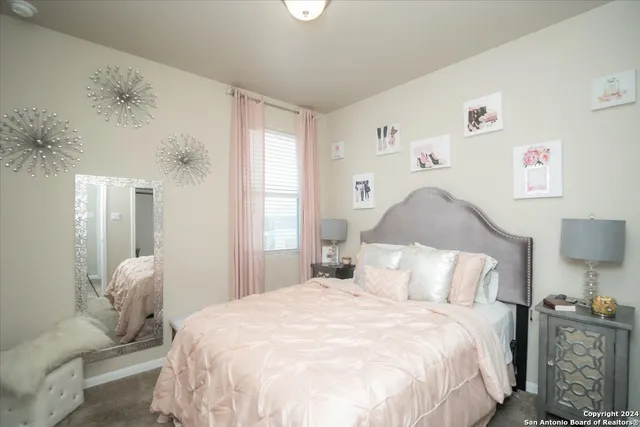 a bedroom with a bed and a painting on the wall