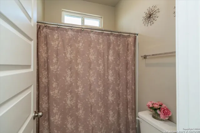a bathroom with a shower curtain