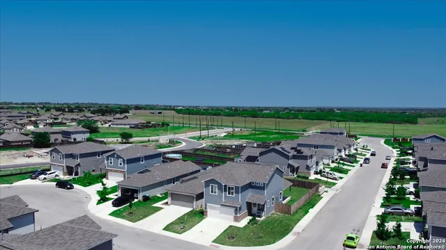 an aerial view of a house with outdoor space