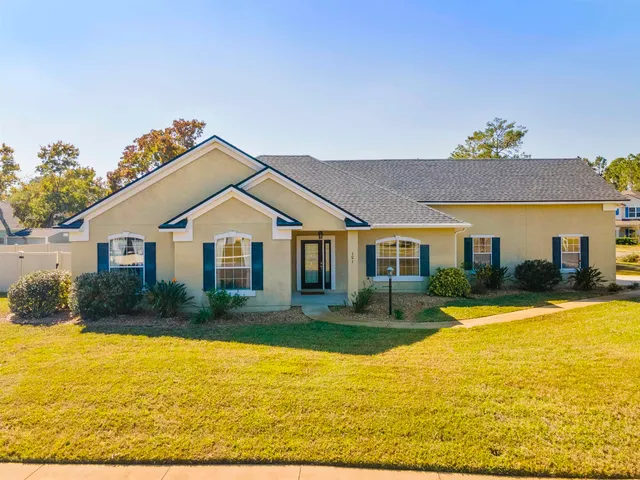 a front view of a house with swimming pool having outdoor seating