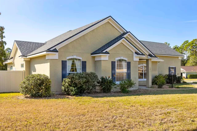 a front view of house with yard and green space