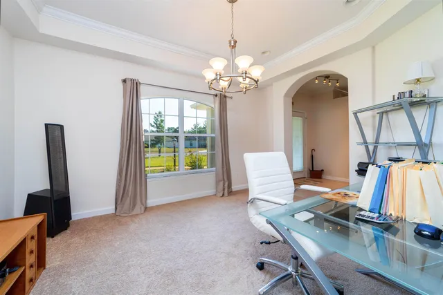 a view of a room with furniture and a chandelier