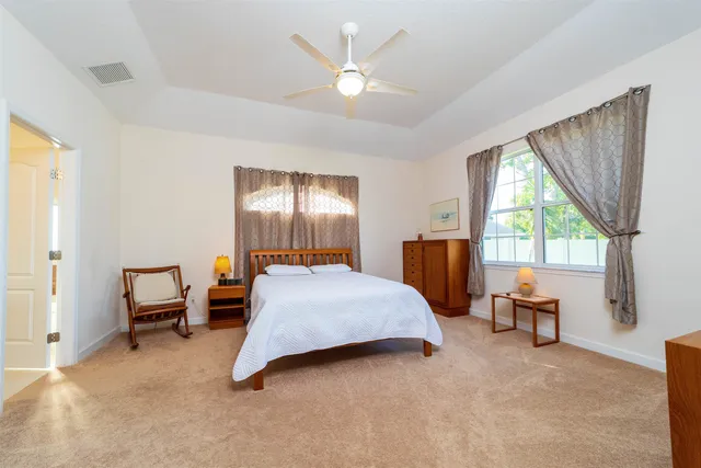 a bedroom with a bed and large window