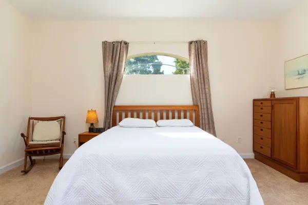 a bedroom with a bed and a dresser