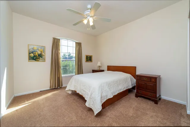 a spacious bedroom with a bed and a window
