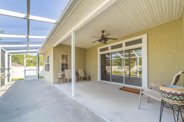 a view of a room with furniture wooden floor and windows