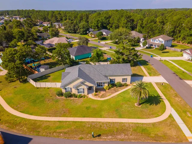 an aerial view of residential houses with outdoor space